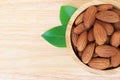 Almonds in wooden bowl on wood table Royalty Free Stock Photo