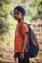 Almora, uttrakhand/ india - june 14 2020 : a portrait of a small girl with white marks on her face going to school with a heavy