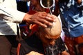 Almora, uttrakhand / India - May 26 2020 : A close of a hand and a head while cutting hairs, indian tradition of cutting hair