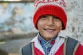 Almora, Uttrakhand / India- May 25 2020 : Portrait of a Young kid smiling wearing red cap and red uniform of school