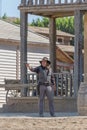 Live performance scenes, sheriff cowboy walking with shotgun on hands, on Oasys - Mini Hollywood, Spanish Western theme park, Alm