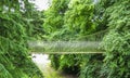 Alnwick wooden Treehouse, wooden and rope bridge within trees, Alnwick Garden, in the English county of Northumberland