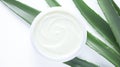 Aloe vera cream with aloe vera leaves on white