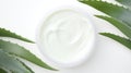 Aloe vera cream with aloe vera leaves on white