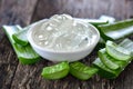 Aloe vera gel in bowl with on wooden table Royalty Free Stock Photo