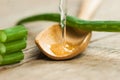 Aloe Vera gel close up. Sliced Aloevera leaf and gel with wooden spoon Royalty Free Stock Photo