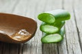 Aloe Vera gel close up. Sliced Aloevera leaf and gel with wooden spoon Royalty Free Stock Photo