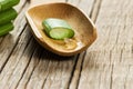 Aloe Vera gel close up. Sliced Aloevera leaf and gel with wooden spoon Royalty Free Stock Photo