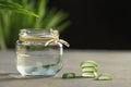 Aloe Vera gel close-up. Sliced Aloe vera plants leaf and gel pouring into jar Royalty Free Stock Photo