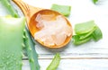 Aloe Vera gel closeup on white wooden background. Organic sliced aloevera leaf and gel, natural organic cosmetic ingredients Royalty Free Stock Photo