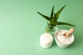 Aloe vera in glass jar, cream box, salt scrub in ceramic bowl Royalty Free Stock Photo