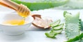 Aloe Vera with honey closeup on white wooden background. Sliced Aloevera natural organic renewal cosmetics, alternative medicine