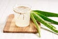 Aloe vera juice in a glass on wooden paddle board Royalty Free Stock Photo