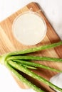 Aloe vera juice in a glass on wooden paddle board Royalty Free Stock Photo