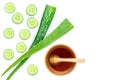 Aloe vera leaf with water drops and cucumber with honey.