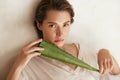 Aloe Vera. Woman Holding Leaf And Looking At Camera. Beauty Portrait Of Tender Model With Natural Makeup.