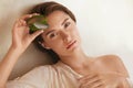 Aloe Vera. Woman Holding Slices Of Leaf And Looking At Camera. Beauty Portrait Of Tender Model With Natural Makeup.