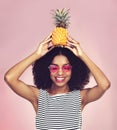 Aloha to you. Studio shot of a beautiful young woman posing with a pineapple on her head. Royalty Free Stock Photo