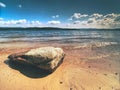 Alone big stone in water close to the beach. Stormy sky above Royalty Free Stock Photo