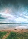 Alone big stone in water close to the beach. Stormy sky above Royalty Free Stock Photo