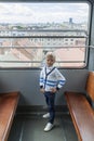 alone boy climb in an empty funicular and look at the panorama of the city of Zagreb