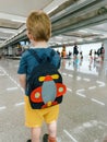 Alone boy waiting at airport with backpack Royalty Free Stock Photo