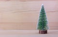 Alone christmas tree with wooden background. Wallpaper.