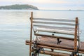 Alone empty wooden white bench or chair near the sea of island.