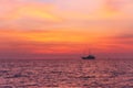 Alone fisherman boat in calm sea at sunset in the evening. Andaman sea, Thailand. Royalty Free Stock Photo