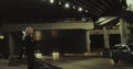 Alone girl standing highway looking at cars passing through driving tunnel.