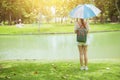 Alone girl teen in the park standing with umbrella Royalty Free Stock Photo