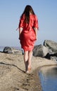 Alone girl walking on the coast