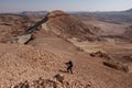 Alone hiker on a hiking trail in a remote desert region.
