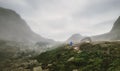 Alone hiker photographer walk in foggy mountains