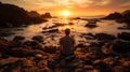 Alone human standing in rocky seashore at sunset