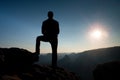 Alone male hiker in mountain landscape at sunset at horizon. Beautiful colorful mountain panorama in the evening in the mountains.