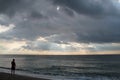 Alone man on the beach. Storm weather on the sea.