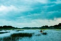 Alone man canoeing in the outdoor lake of south carolina marsh with dramatica cloudy sky Royalty Free Stock Photo