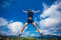 Alone man Jumping for Joy on a Grass Hill above horizon line Royalty Free Stock Photo