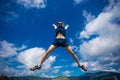 Alone man Jumping for Joy on a Grass Hill above horizon line Royalty Free Stock Photo