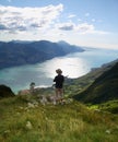 Alone man overview Lake Garda with Monte Baldo