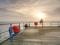 Alone man on pier look over handrail into water Royalty Free Stock Photo