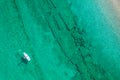 Alone man rowing on SUP board on aquamarine, blue sea water with coral in lagoon. Aerial top view paddleboard. Surfing. Royalty Free Stock Photo