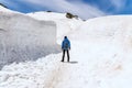 Alone man standing on snow walkway at Tateyama Kurobe Alpine Route