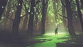 Alone man with torch standing in fairy tale forest Royalty Free Stock Photo
