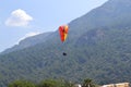 Alone paraglider flying in the blue sky against the background of clouds. Paragliding in the sky on a sunny day Royalty Free Stock Photo