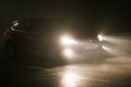 alone red Ford car on empty night foggy road Royalty Free Stock Photo