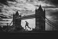 Alone runner in empty streets of london in Coronavirus, Covid-19 quarantine time. Tower Bridge in background Royalty Free Stock Photo