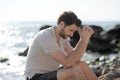 Alone sad man sitting on a beach Royalty Free Stock Photo