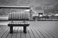 Alone scratched wooden bench on the wood panel floor  photo in black and white color style Royalty Free Stock Photo